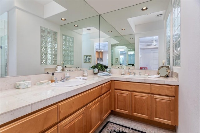 bathroom with tile patterned floors, ceiling fan, and vanity