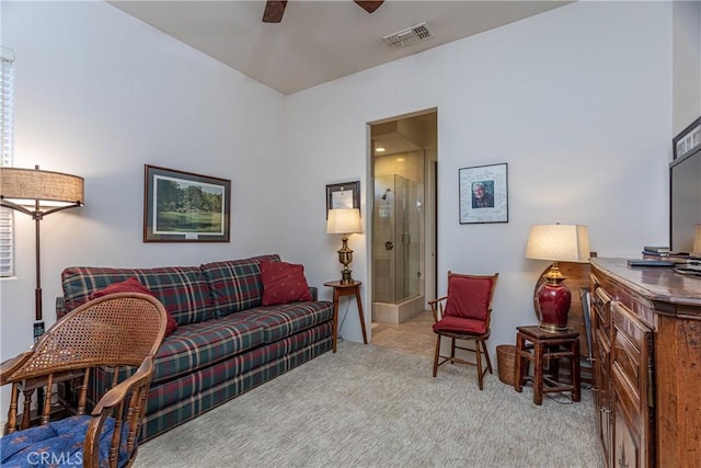 carpeted living room with ceiling fan