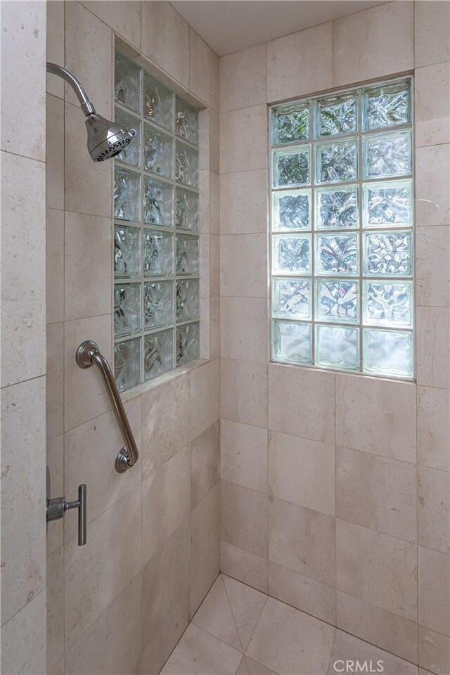 bathroom featuring a shower with shower door