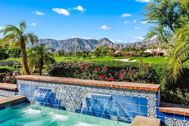 view of pool featuring a mountain view and a jacuzzi