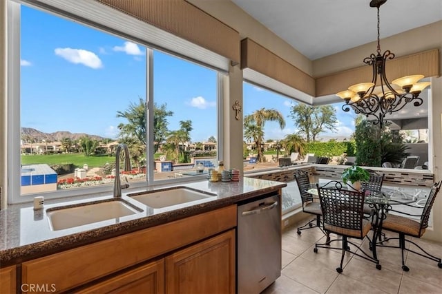 interior space featuring a mountain view, a healthy amount of sunlight, sink, and an inviting chandelier