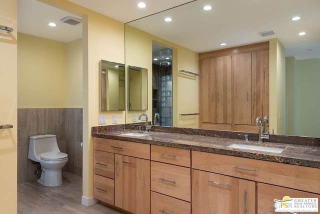 bathroom featuring hardwood / wood-style flooring, vanity, and toilet