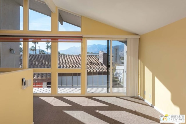 doorway featuring a mountain view, carpet floors, and a healthy amount of sunlight