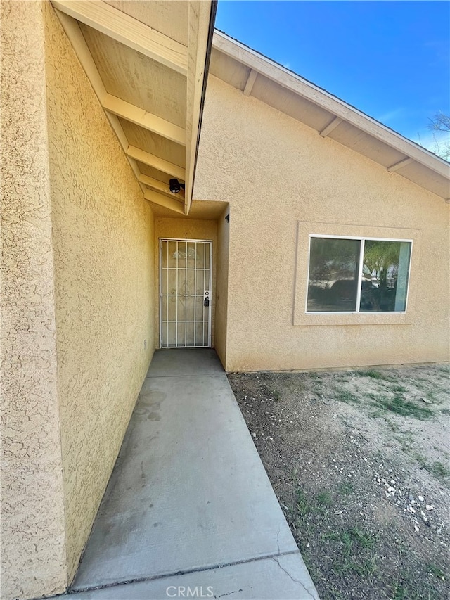 view of exterior entry with a patio area