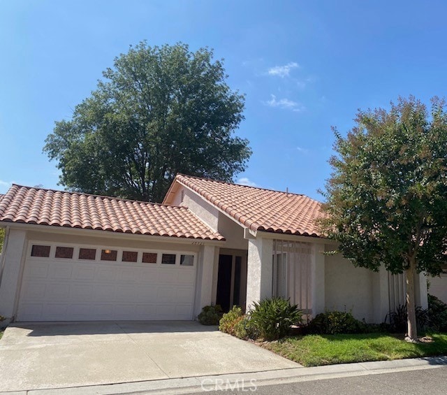 mediterranean / spanish-style home featuring a garage