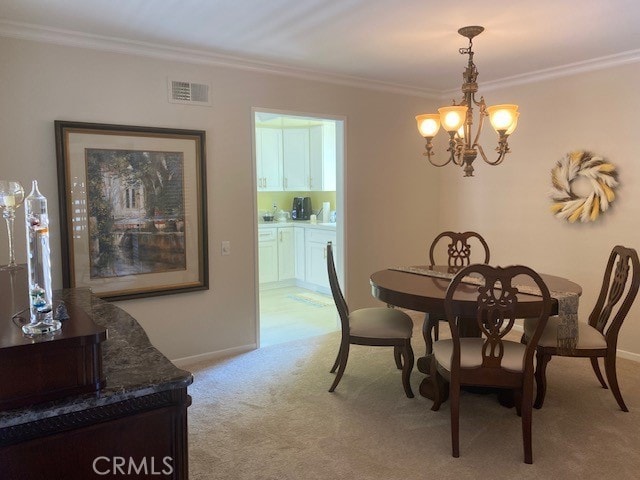 carpeted dining area with crown molding and an inviting chandelier