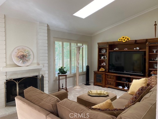 living room featuring a brick fireplace, light colored carpet, lofted ceiling, and ornamental molding