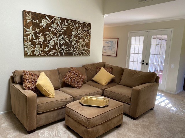 carpeted living room with ornamental molding and french doors