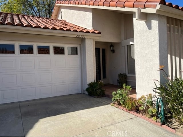 view of exterior entry featuring a garage