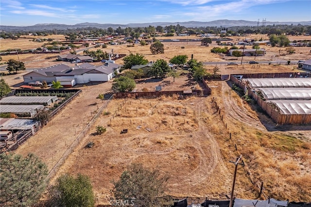 birds eye view of property with a mountain view