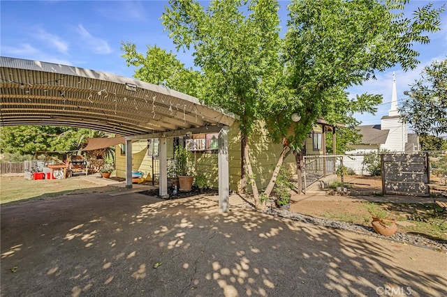 view of parking / parking lot featuring a carport