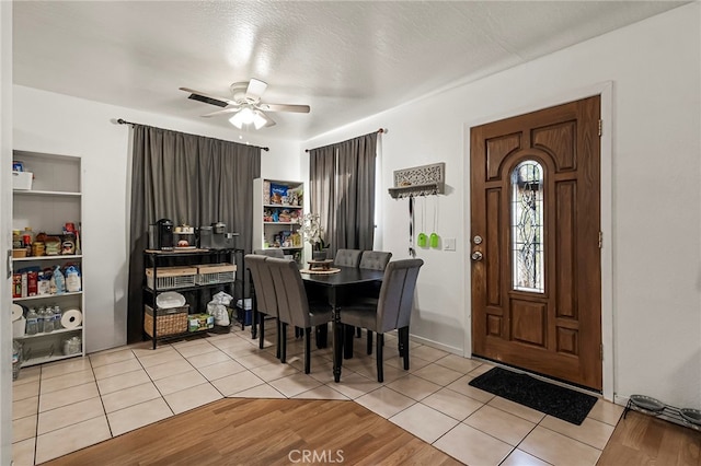 foyer with a textured ceiling, ceiling fan, and light hardwood / wood-style flooring