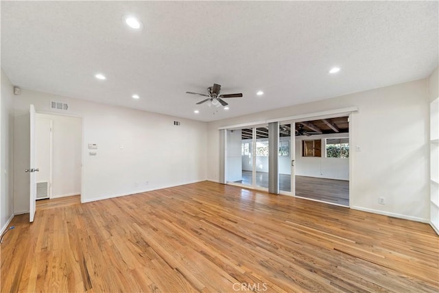 spare room featuring ceiling fan and light wood-type flooring