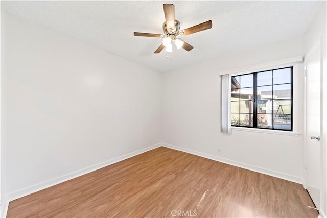 empty room with light hardwood / wood-style floors and ceiling fan