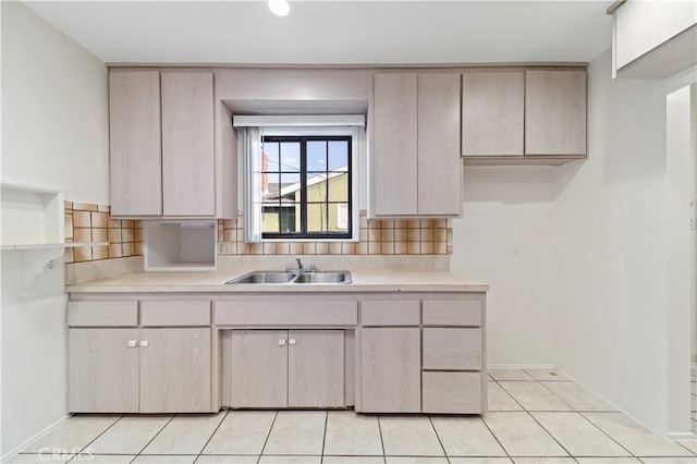 kitchen with sink, backsplash, and light tile patterned floors