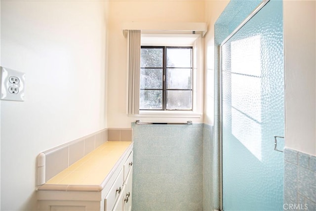 bathroom with an enclosed shower and vanity