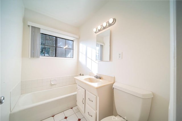 bathroom with toilet, vanity, and a tub