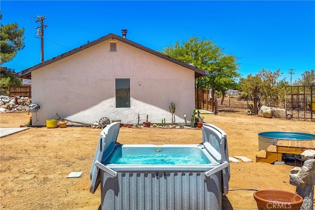 view of swimming pool with a hot tub