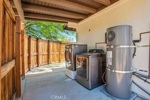 exterior space with washing machine and clothes dryer, strapped water heater, and wooden ceiling