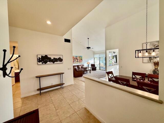 tiled living room featuring ceiling fan