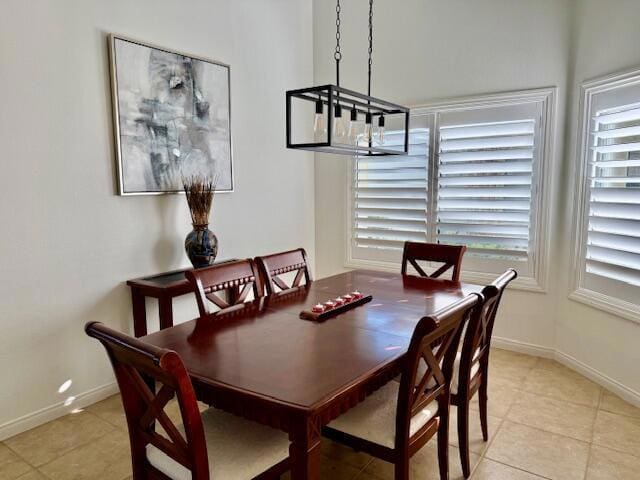 dining area with light tile patterned floors and a notable chandelier