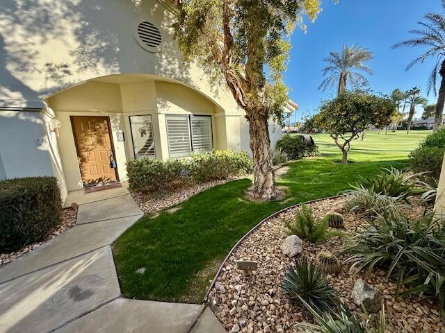 entrance to property featuring a lawn