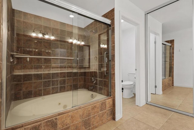 bathroom featuring toilet, shower / bath combination with glass door, and tile patterned flooring