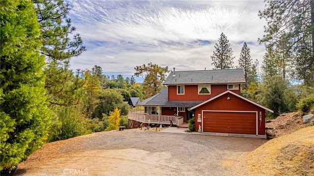 view of front of house featuring a garage and a wooden deck