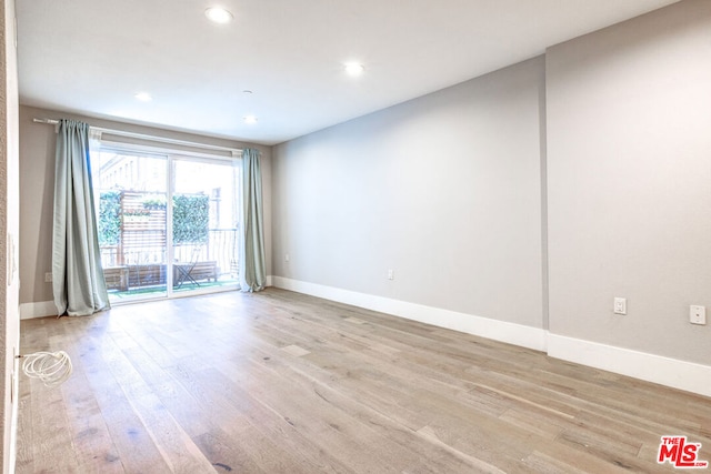 spare room with light wood-type flooring