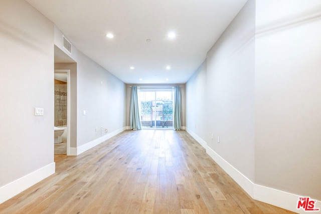 spare room featuring light hardwood / wood-style flooring