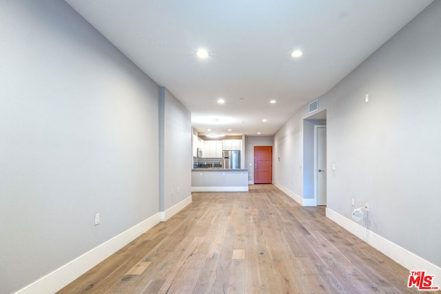 unfurnished living room featuring light hardwood / wood-style floors