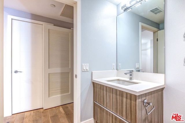 bathroom with hardwood / wood-style flooring and vanity