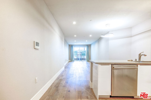 interior space with light hardwood / wood-style floors and sink