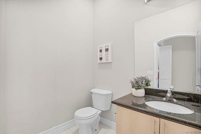 bathroom featuring tile patterned floors, vanity, and toilet