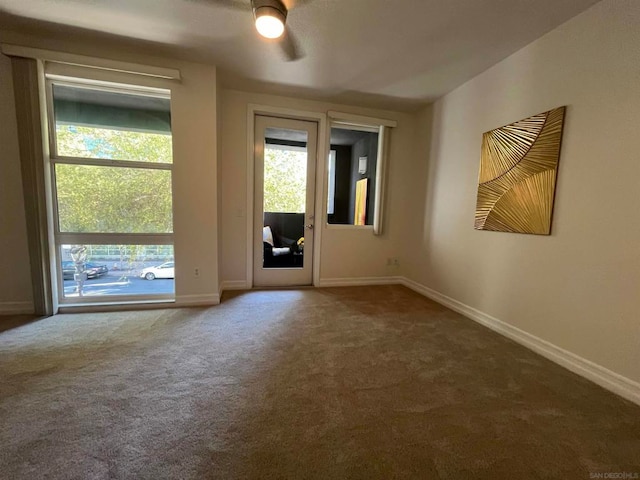 interior space featuring carpet flooring, ceiling fan, and a healthy amount of sunlight