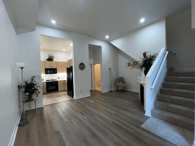 living room with vaulted ceiling and dark hardwood / wood-style flooring