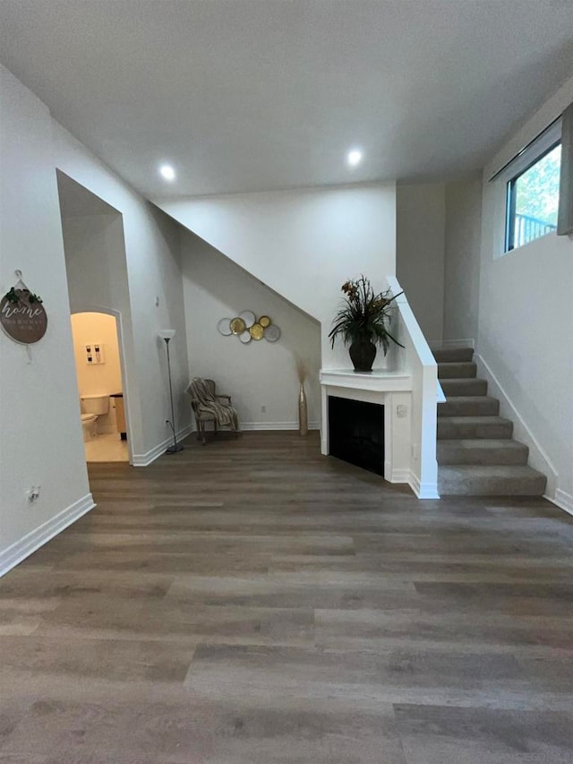 unfurnished living room featuring dark wood-type flooring