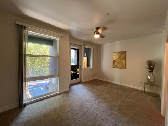 carpeted empty room featuring ceiling fan