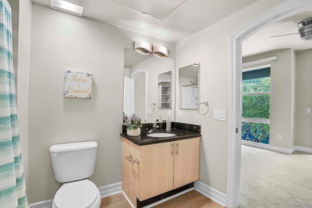 bathroom featuring vanity, toilet, and ceiling fan