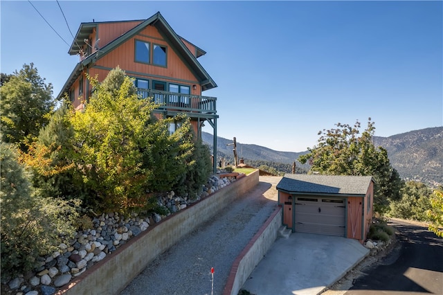 view of front of home with a balcony, a mountain view, and a garage