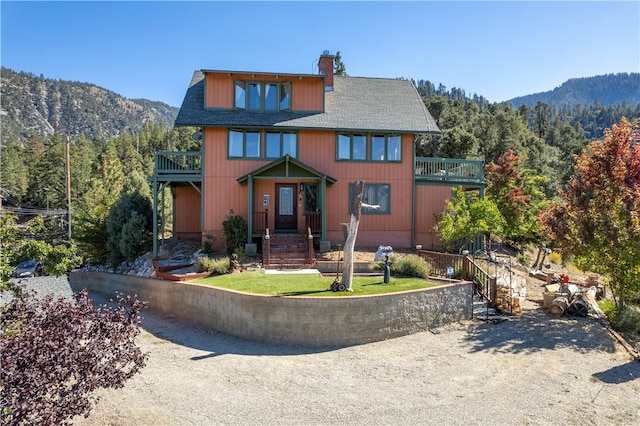 front of property with a balcony and a mountain view