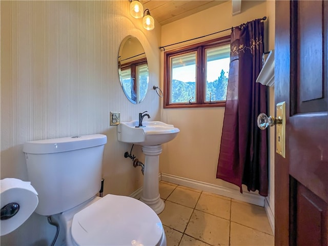 bathroom with tile patterned flooring and toilet