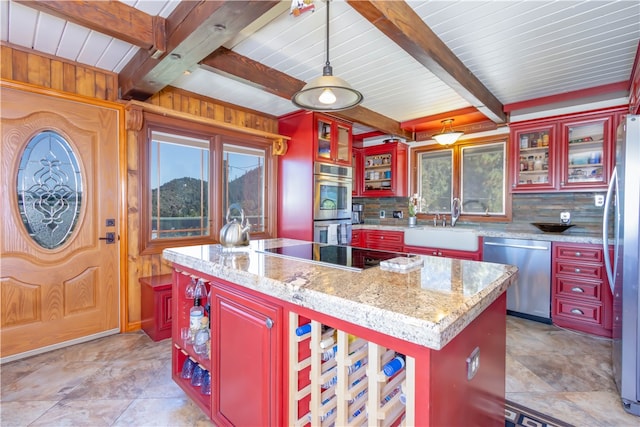 kitchen with light stone counters, a center island, hanging light fixtures, decorative backsplash, and stainless steel appliances