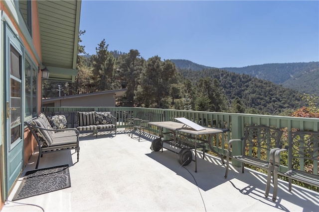 view of patio with an outdoor living space and a mountain view