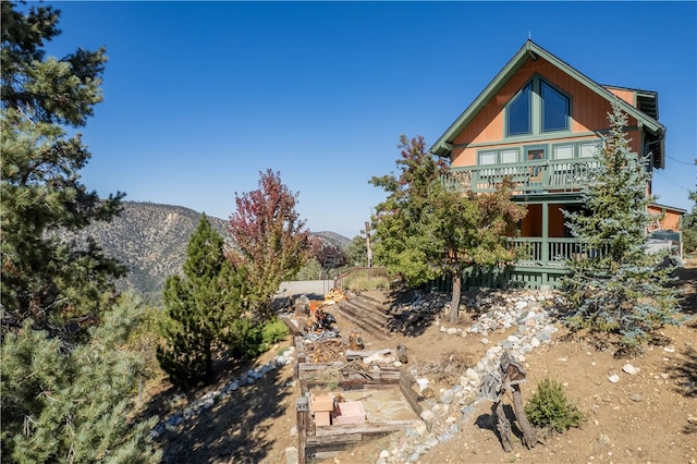 view of yard featuring a balcony and a mountain view