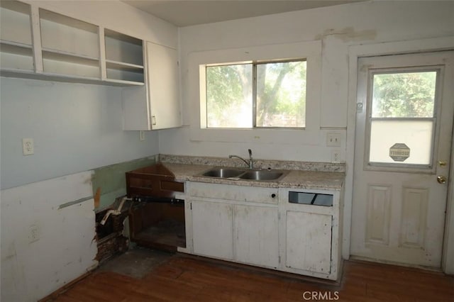 kitchen featuring dark wood-type flooring, sink, and white cabinetry