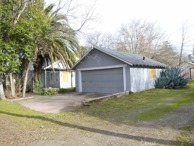 view of side of property with an outdoor structure and a garage