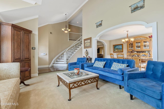 carpeted living room featuring high vaulted ceiling, a notable chandelier, and crown molding