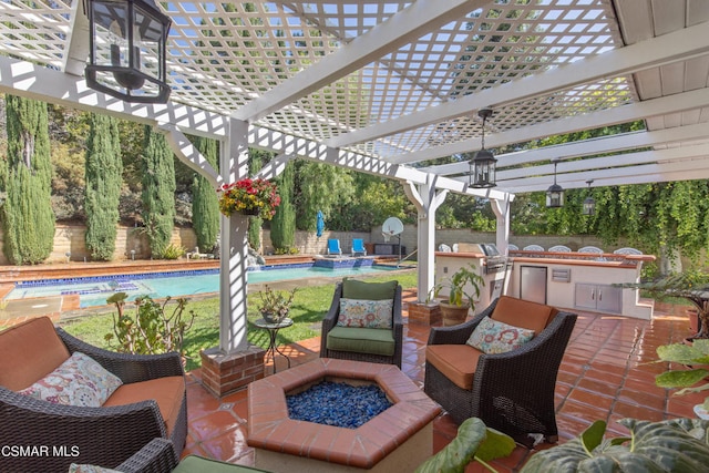 view of patio with a grill, an outdoor fire pit, a pergola, and exterior kitchen