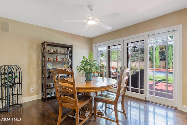 dining space with ceiling fan, dark hardwood / wood-style flooring, and french doors